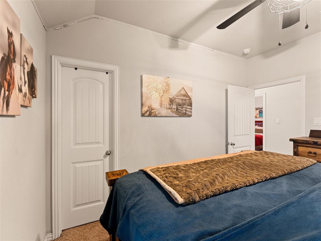 109 Highland Hills Boulevard Decatur, TX 76234 - Photo 24 of 36 a bedroom with a bed and painting on the wall