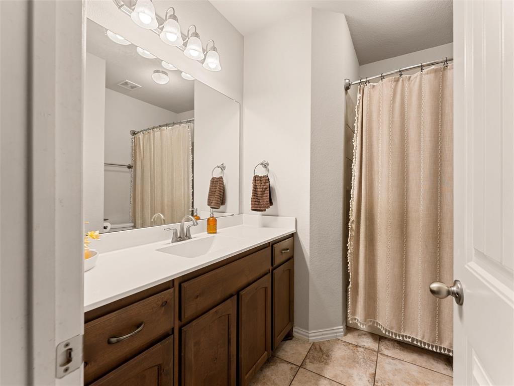 109 Highland Hills Boulevard Decatur, TX 76234 - Photo 27 of 36 a bathroom with a double vanity sink and mirror