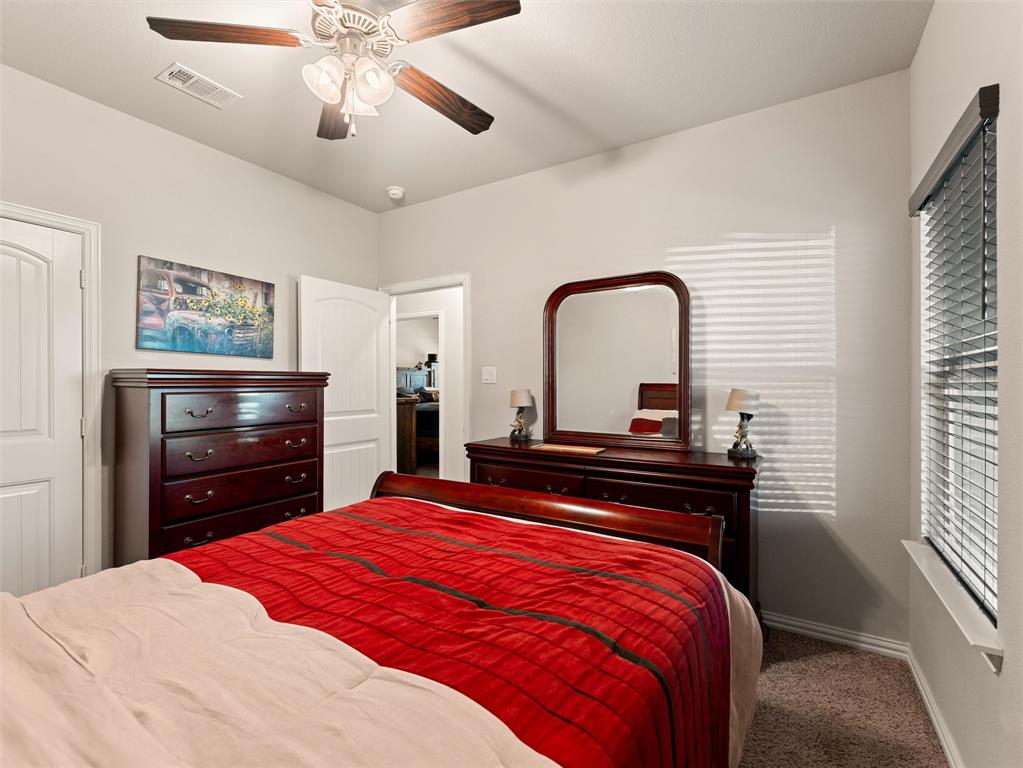 109 Highland Hills Boulevard Decatur, TX 76234 - Photo 29 of 36 a bedroom with a bed and a dresser with the outer view