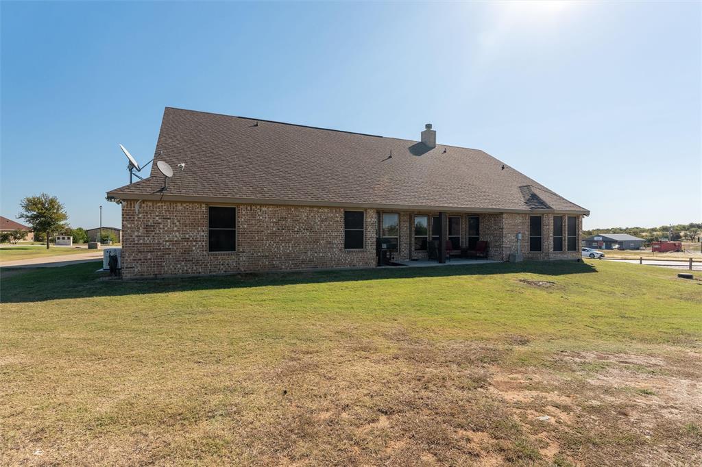 109 Highland Hills Boulevard Decatur, TX 76234 - Photo 31 of 36 a front view of a house with a yard