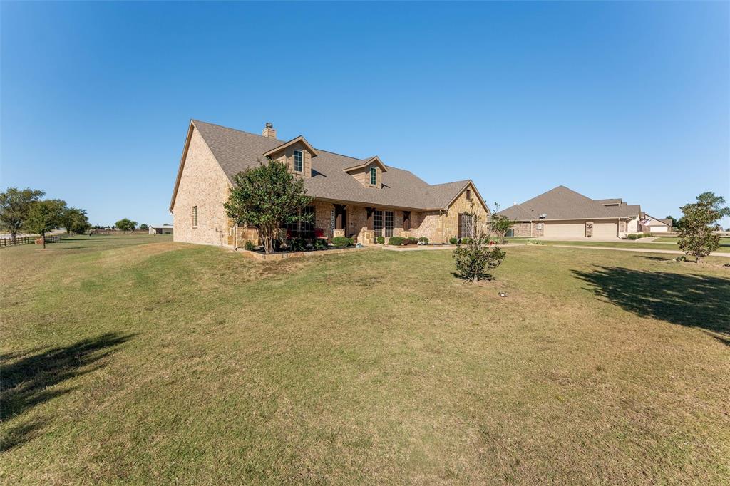 109 Highland Hills Boulevard Decatur, TX 76234 - Photo 4 of 36 a front view of a house with a yard