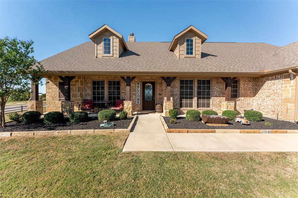 109 Highland Hills Boulevard Decatur, TX 76234 - Photo 5 of 36 front view of a house with a yard