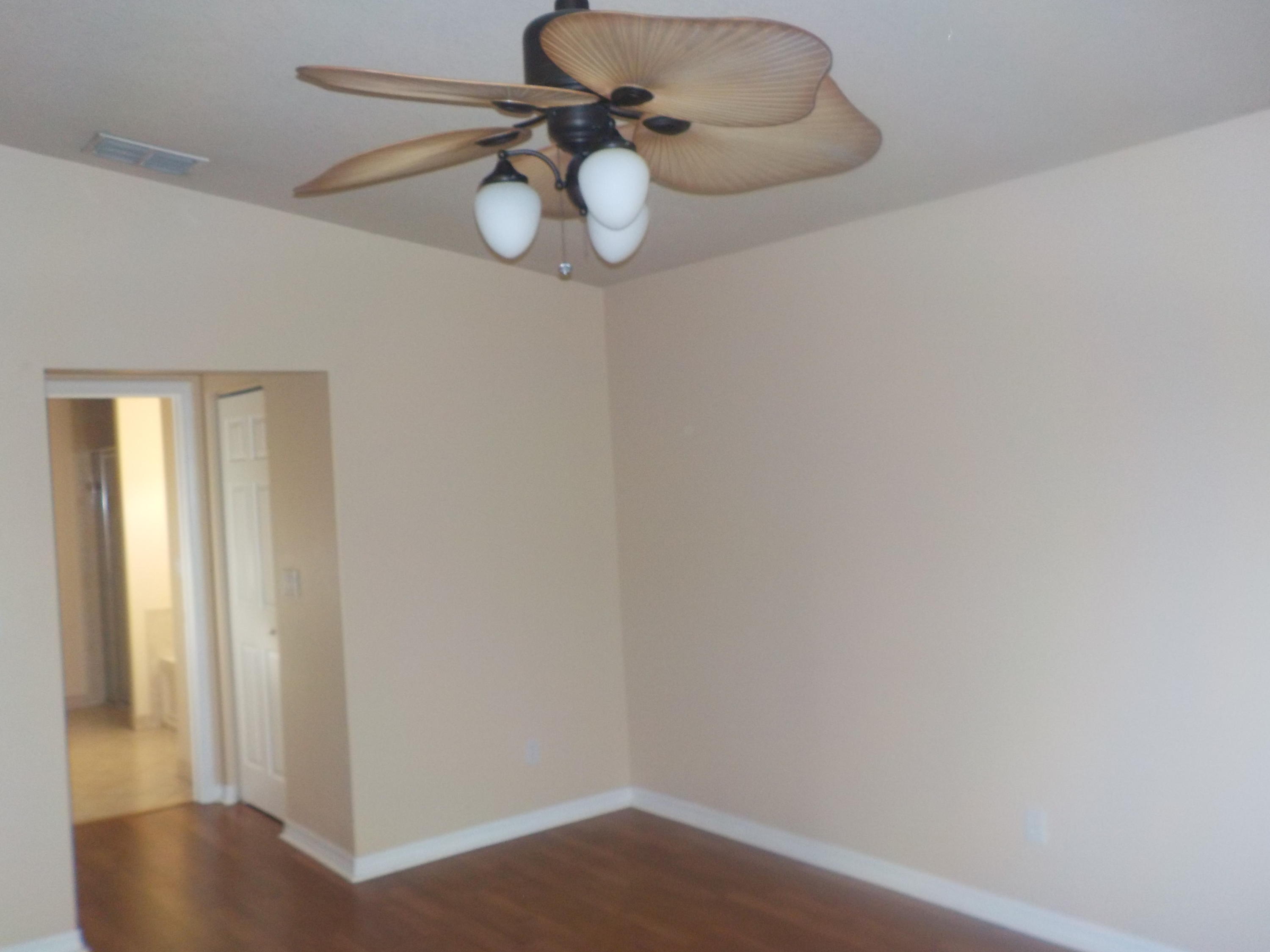 1957 Providence Place Port St. Lucie, FL 34953 - Photo 5 of 15 a view of a chandelier fan and wooden floor