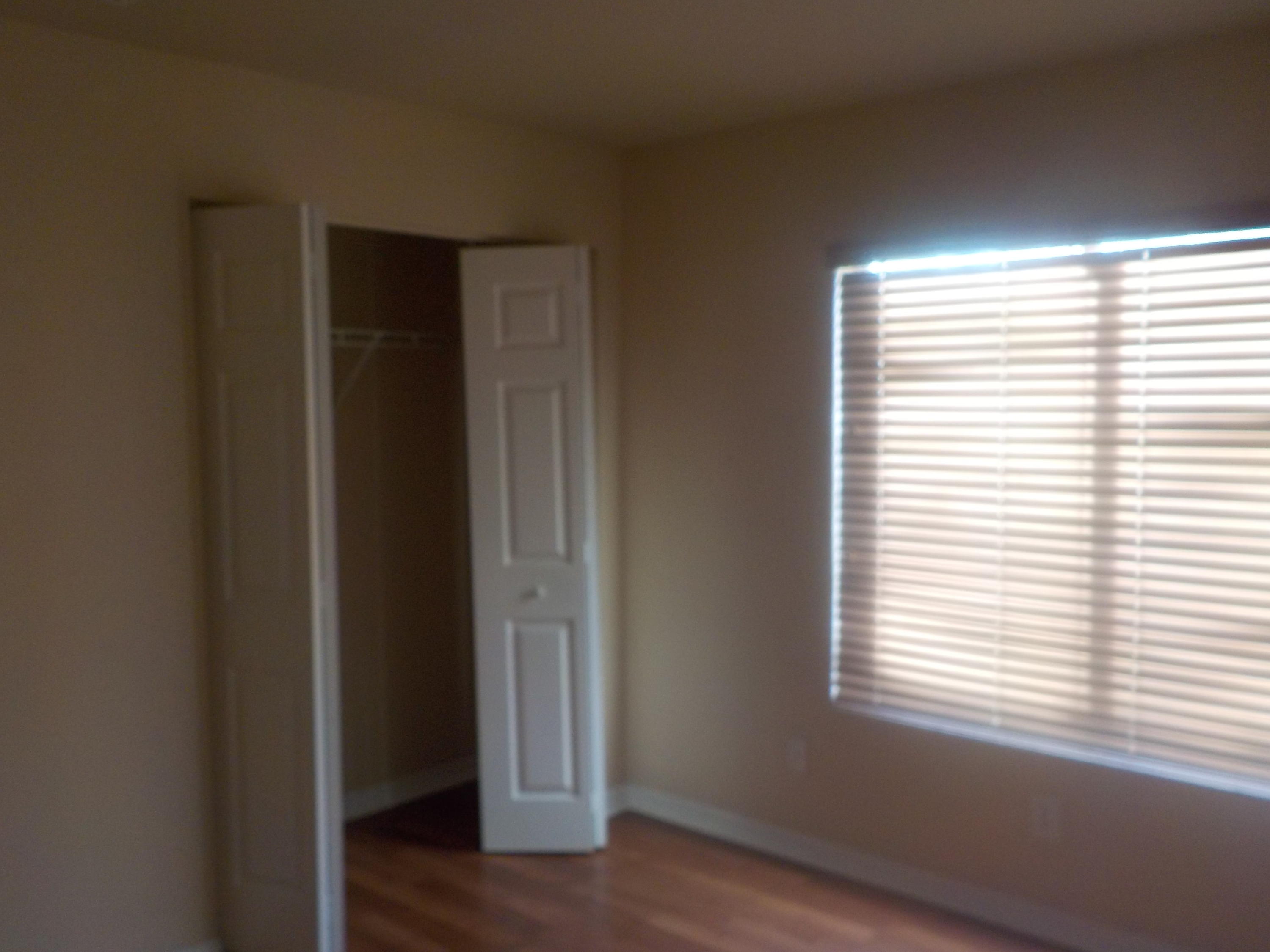 1957 Providence Place Port St. Lucie, FL 34953 - Photo 7 of 15 a view of an empty room with wooden floor and a window