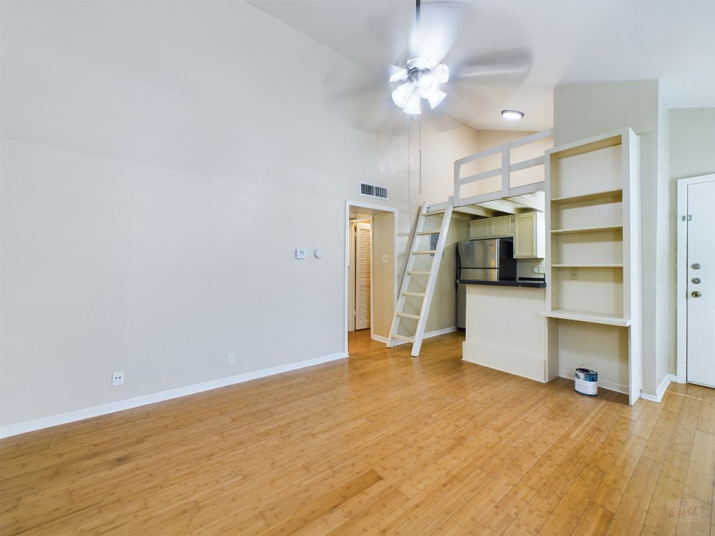 1000 West 26th Street, Unit 210 Austin, TX 78705 - Photo 4 of 19 a view of a kitchen with a sink and a refrigerator