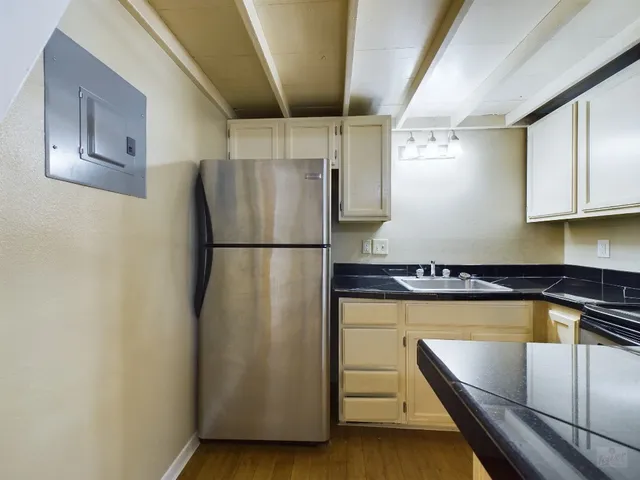a kitchen with granite countertop a stove microwave and sink