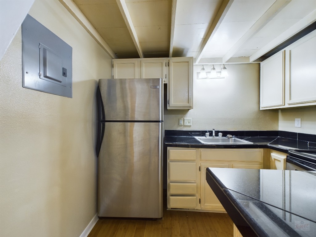 1000 West 26th Street, Unit 210 Austin, TX 78705 - Photo 7 of 19 a view of a refrigerator in kitchen and an empty room