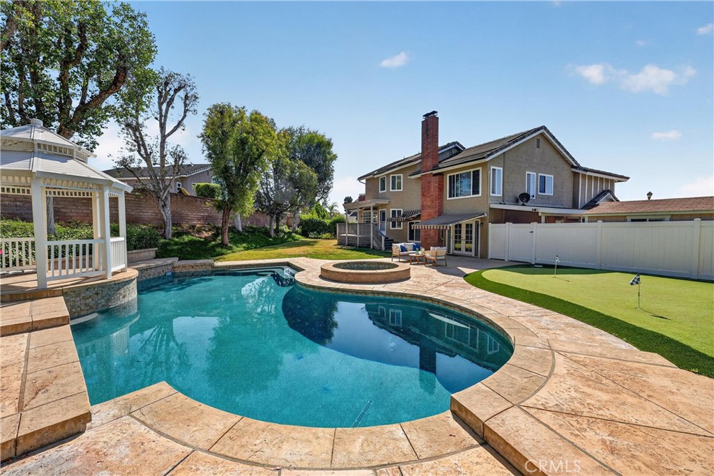 2935 Bluebell Avenue Brea, CA 92821 - Photo 32 of 38 Resort-style backyard featuring a pool, spa, putting green, spacious patio, and gazebo, perfect for entertaining and relaxing