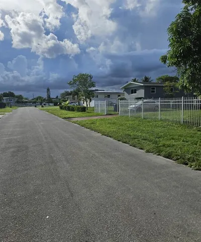 a city view with a big yard and large trees
