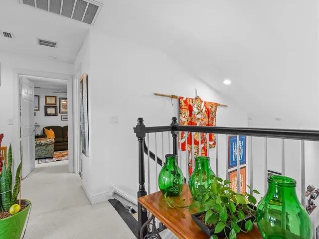 a very nice looking room with a large window and potted plants