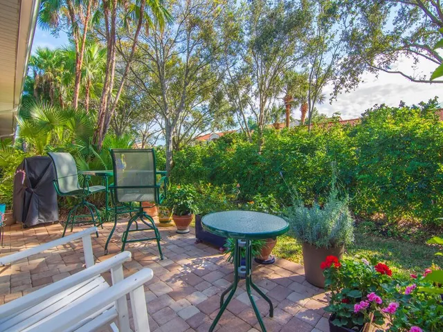 a room with lots of tables a large window and chairs