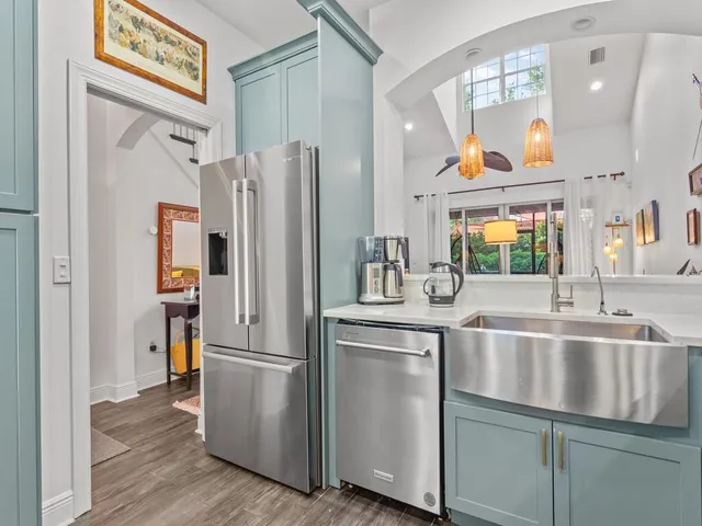 a kitchen with stainless steel appliances granite countertop a refrigerator and a sink