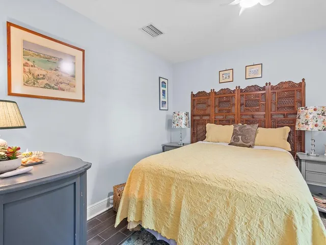 a bed room with a bed and paintings on the wall