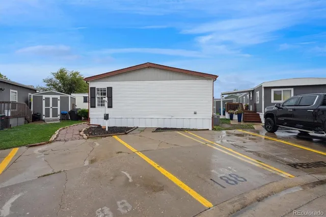 a view of a house with a backyard and a garage