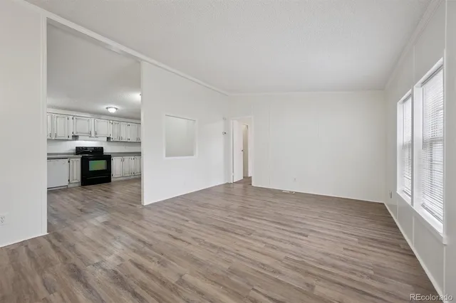 a view of kitchen with wooden floor and electronic appliances