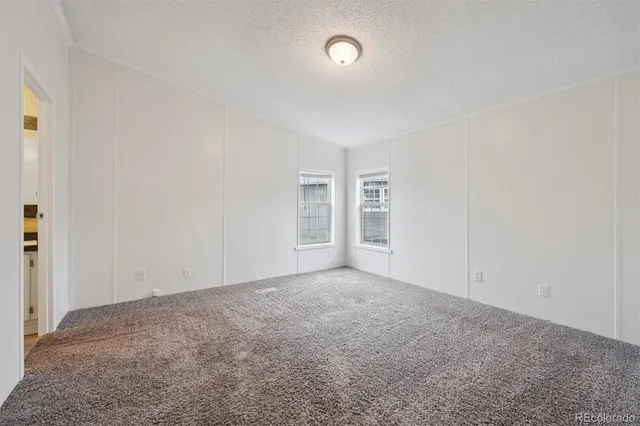 an empty room with a empty space and windows