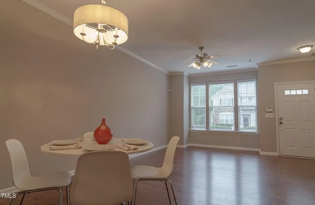 a view of a dining room with furniture wooden floor and chandelier