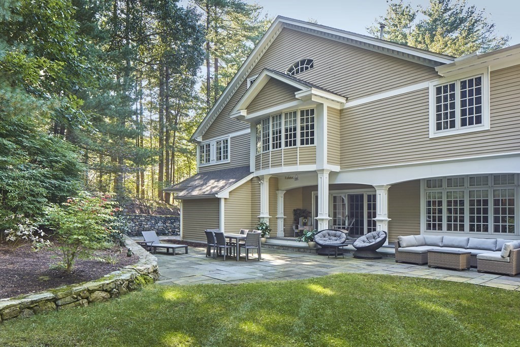 50 Fairview Road Weston, MA 02493 - Photo 3 of 28 a front view of a house with swimming pool and sitting area