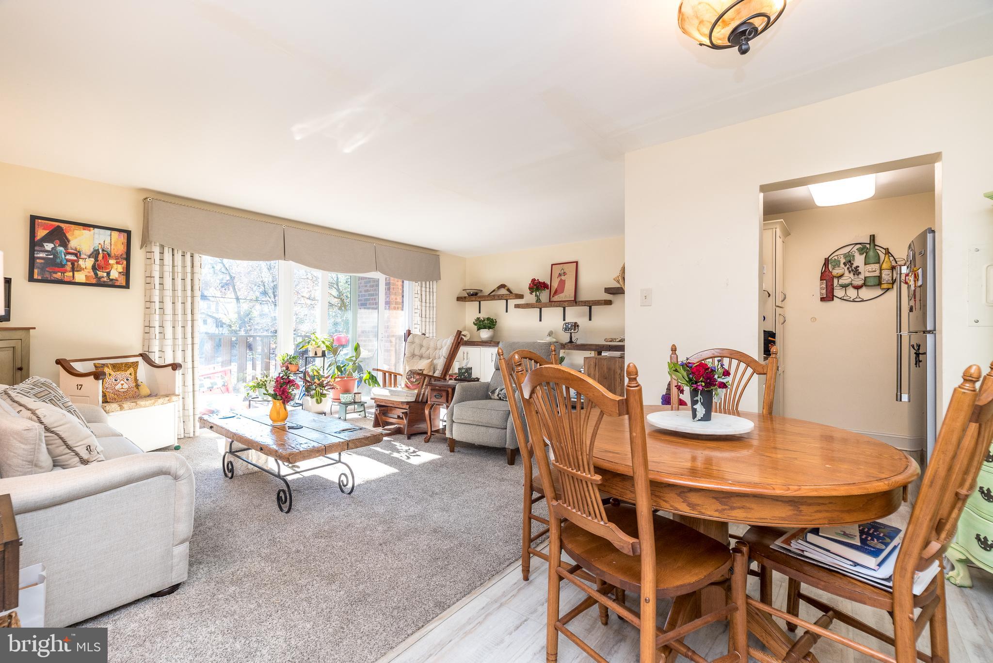 a dining room with furniture and a large window