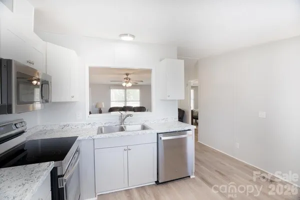a kitchen with a sink stove and cabinets
