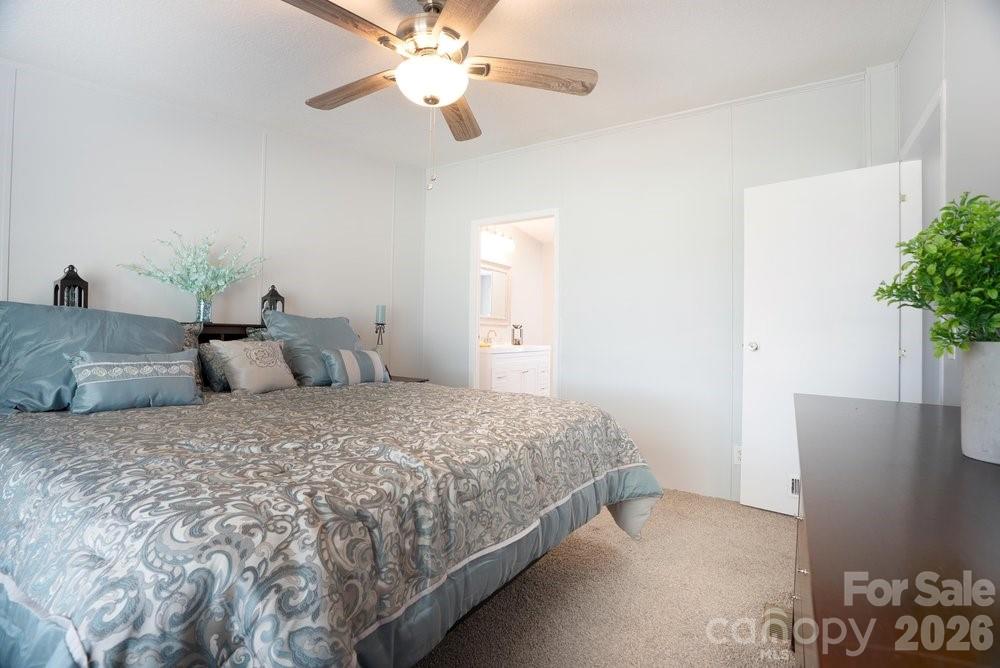 889 Tabor Road Olin, NC 28660 - Photo 12 of 34 a bedroom with a bed and a potted plant