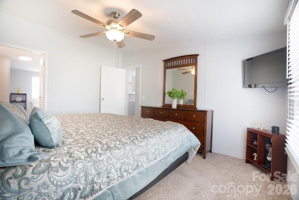 889 Tabor Road Olin, NC 28660 - Photo 13 of 34 a bedroom with a bed and a flat screen tv