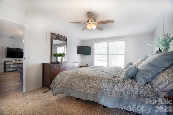 a bedroom with a bed and a tv