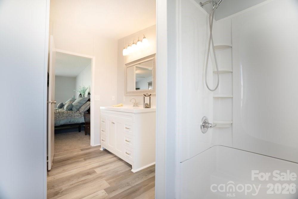 889 Tabor Road Olin, NC 28660 - Photo 17 of 34 a en suite bathroom with a granite countertop sink and a mirror