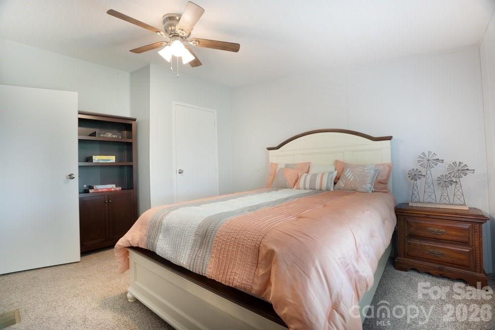 889 Tabor Road Olin, NC 28660 - Photo 18 of 34 a bedroom with a bed and a chandelier