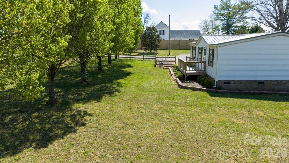 889 Tabor Road Olin, NC 28660 - Photo 24 of 34 a view of a swimming pool with a yard