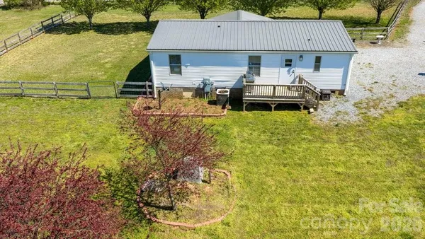 an aerial view of a house with swimming pool and patio