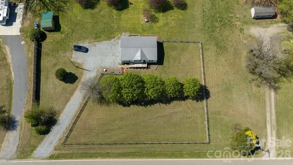 an aerial view of a house with a yard
