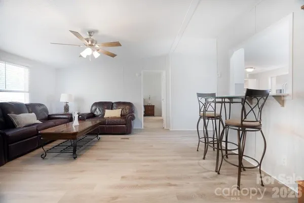 a living room with furniture and a ceiling fan
