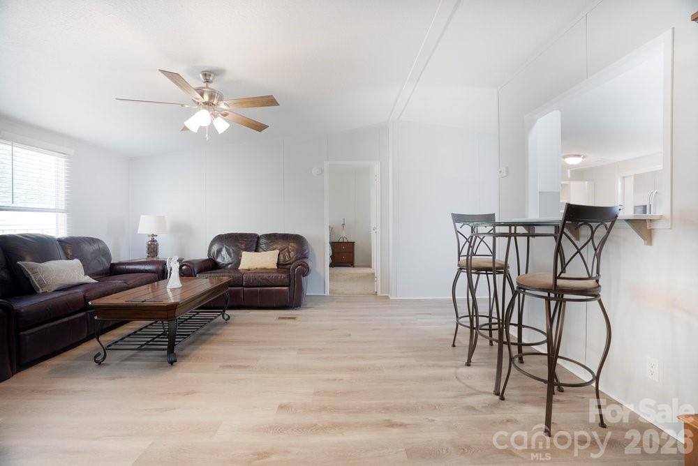 889 Tabor Road Olin, NC 28660 - Photo 4 of 34 a living room with furniture and a ceiling fan