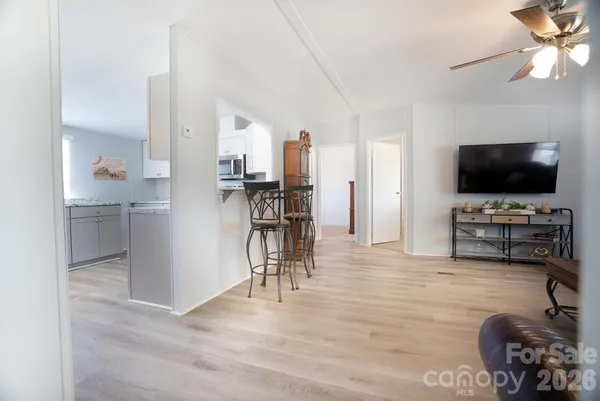 a view of a livingroom with furniture and a flat screen tv