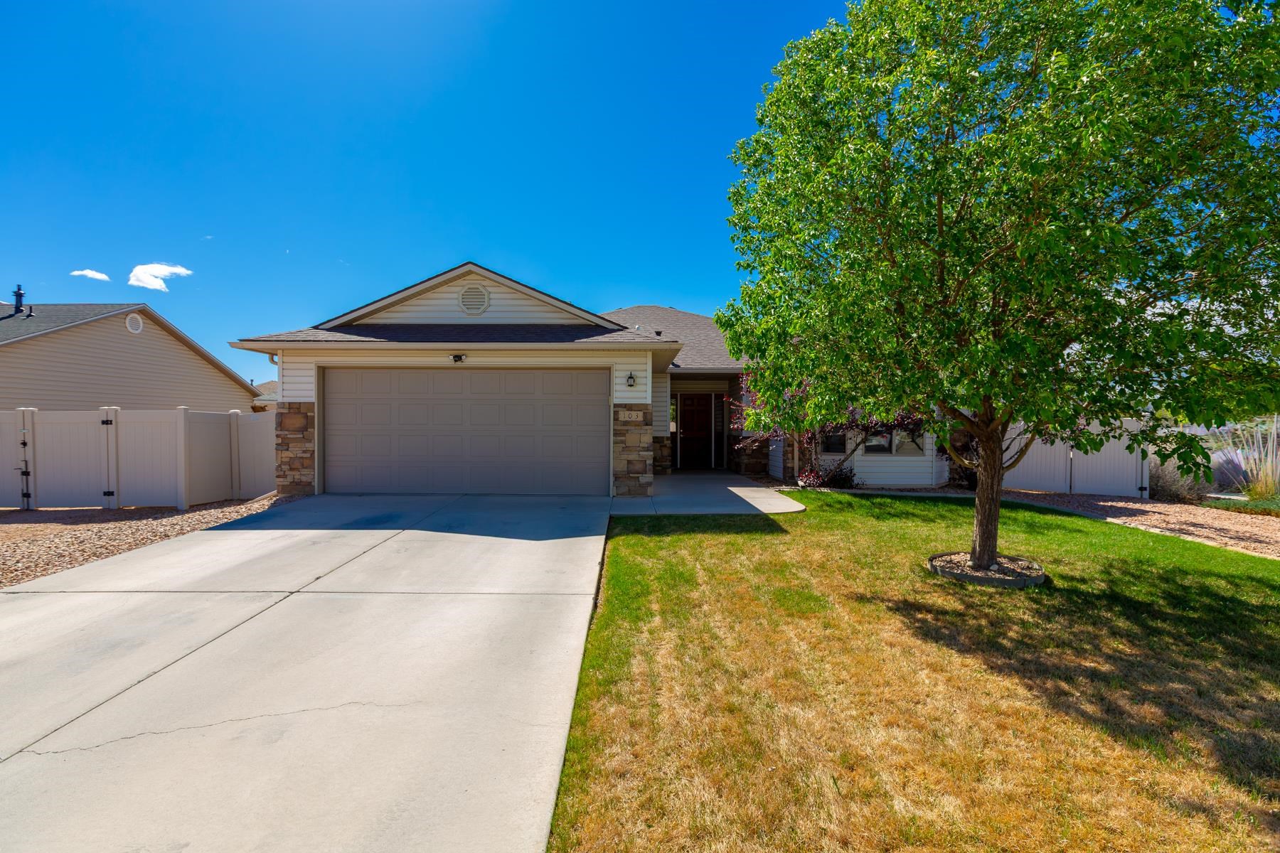 103 Red Rocks Street Fruita, CO 81521 - Photo 1 of 39 a swimming pool with yard in front of it