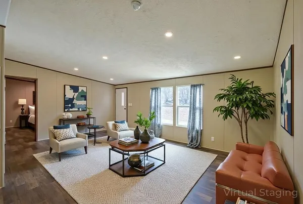a living room with furniture and a potted plant