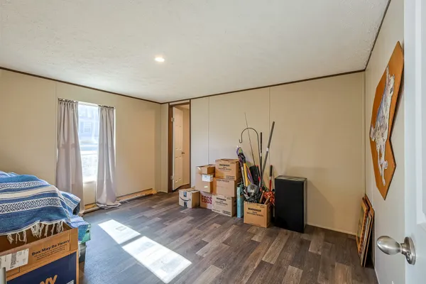 a view of a workspace with wooden floor and bedroom view