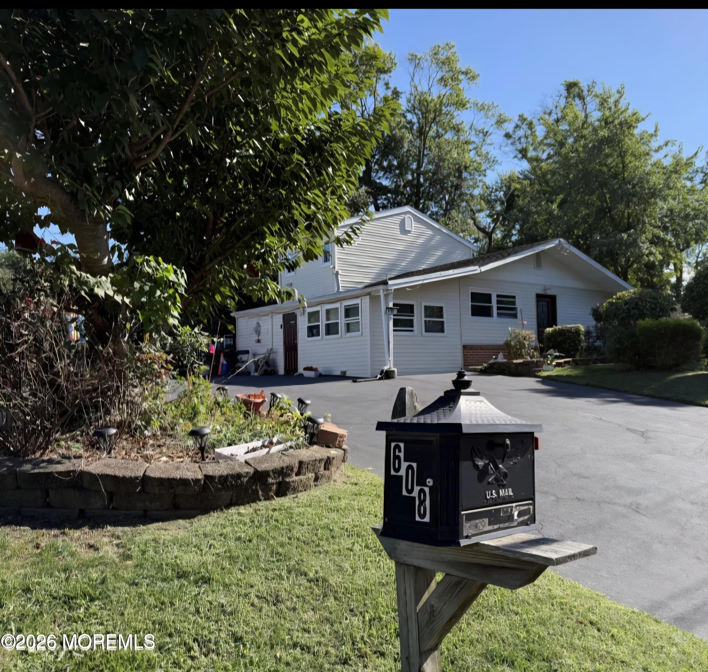 608 Wayside Road Neptune Township, NJ 07753 - Photo 3 of 30 a front view of a house with a yard and outdoor seating