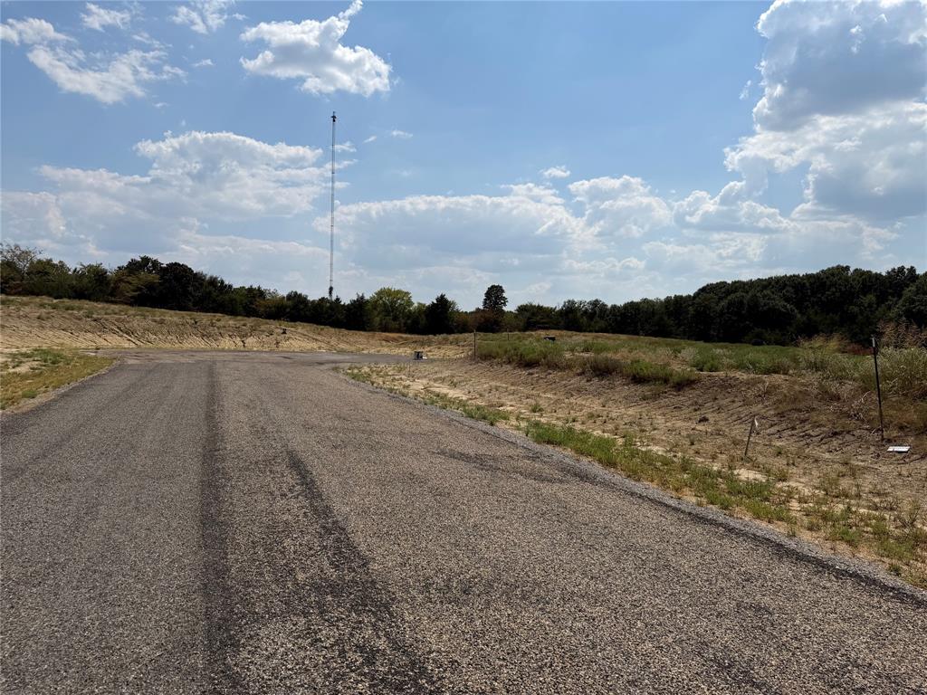 Lot 11 Co Road Farmersville, TX 75442 - Photo 5 of 6 Paved road access leading to undeveloped land with a distant tree line