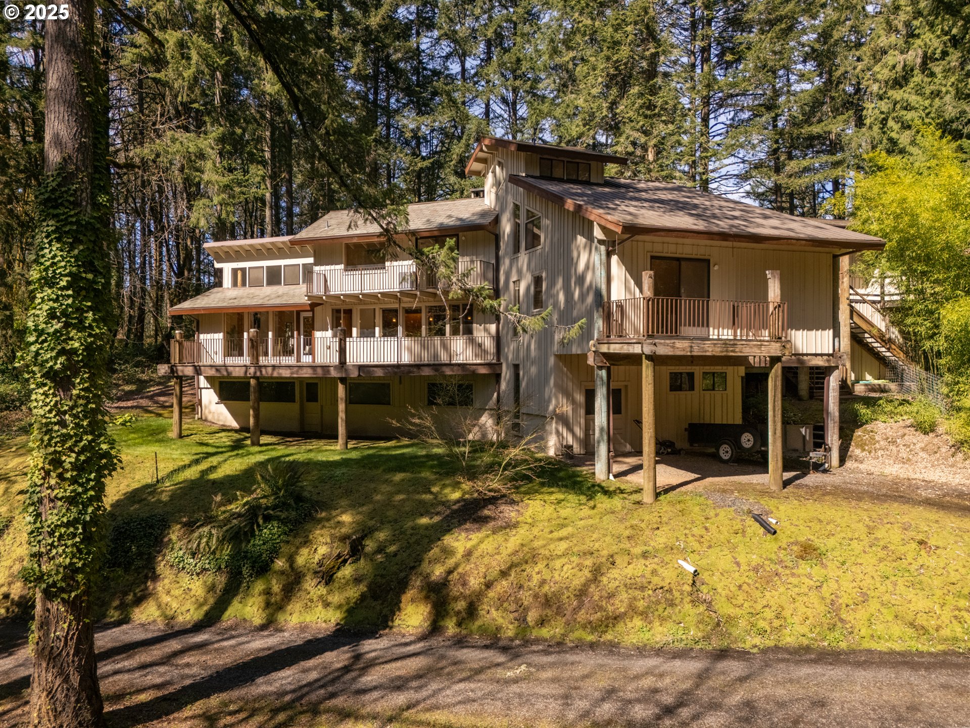 19855 Northeast Trunk Road Dundee, OR 97115 - Photo 42 of 45 a view of a house with large windows and a small yard