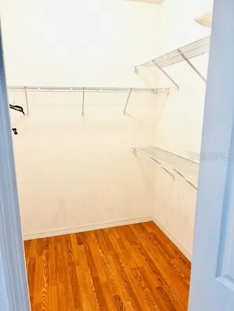 a bedroom with a bed and a flat tv screen on the dresser
