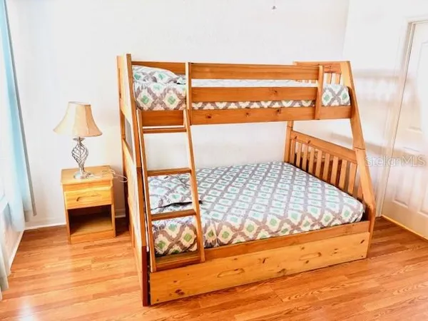 a view of a hallway with wooden floor and stairs