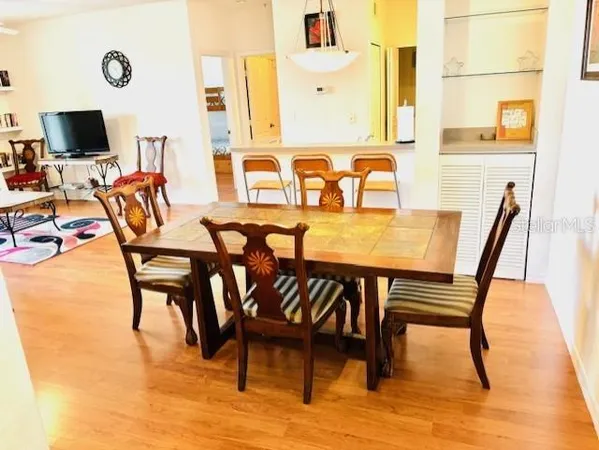 a view of a dining room with furniture and wooden floor
