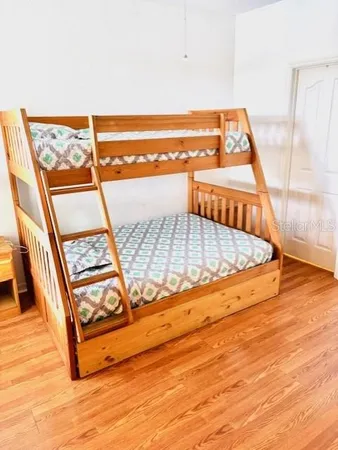 a living room with patio furniture and a flat screen tv