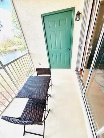 a view of a swimming pool with a patio and wooden fence