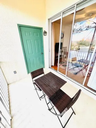 a view of balcony with wooden floor and outdoor seating