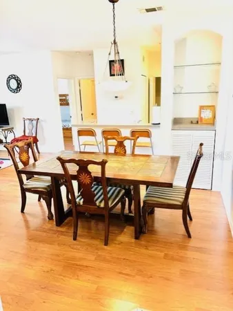 a living room with furniture flat screen tv and a large window