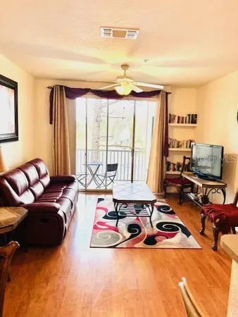 a living room with furniture and floor to ceiling window