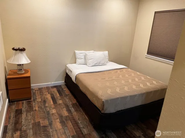 a bed sitting in a bedroom next to a window